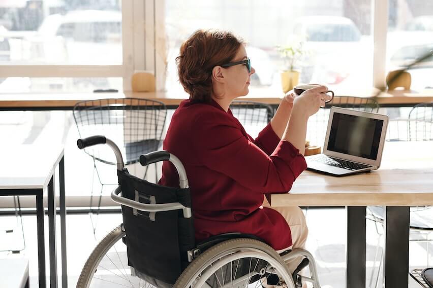 latte factor woman sitting in wheelchair holding coffee